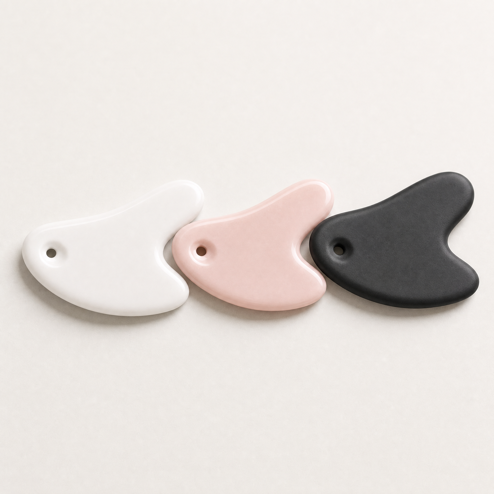 Tessora Ceramic Gua Sha Tool in white, pink and black