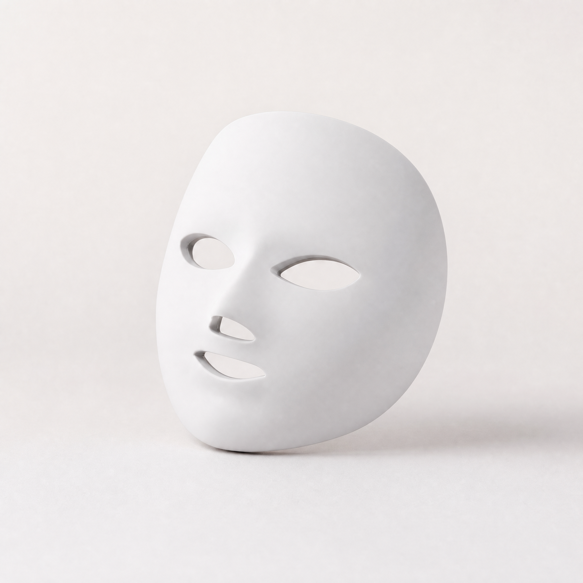 Tessora LED Light Therapy Mask in white on a soft off-white background