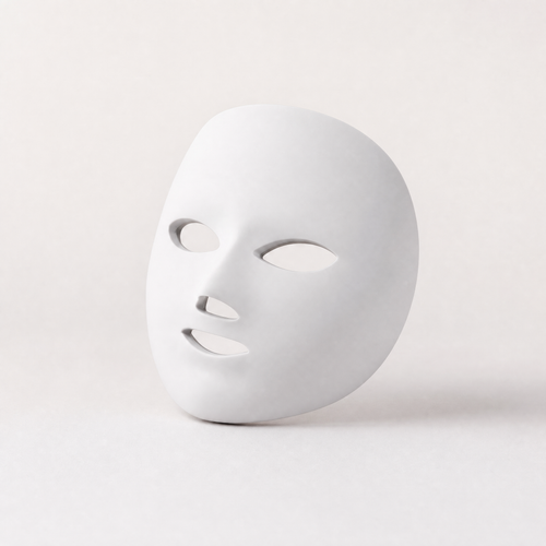 Tessora LED Light Therapy Mask in white on a soft off-white background